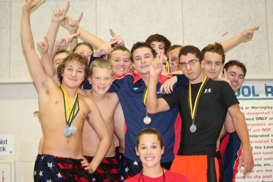 The swim team celebrates their first-place victory. 