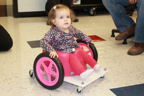 Faith is introduced to her new custom wheelchair built by the engineering class. 