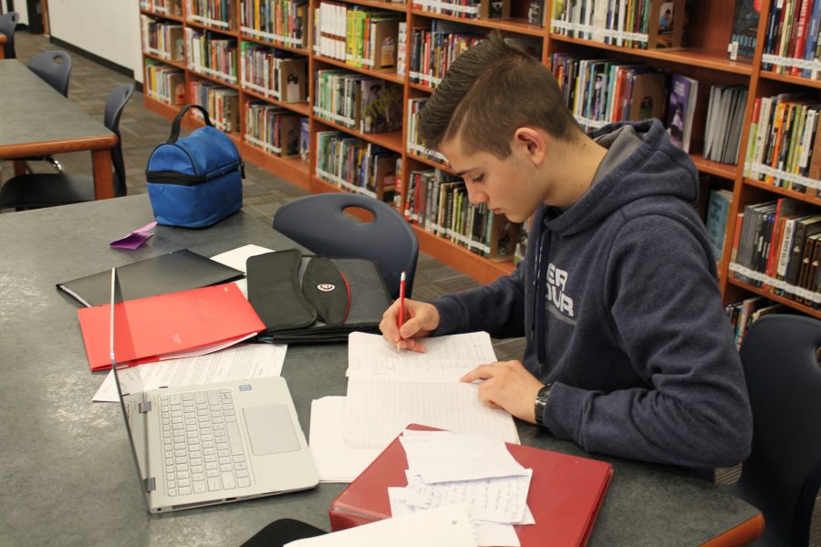 Senior Muhammad Alasgarli locks in to his books while studying in Libertys library.
