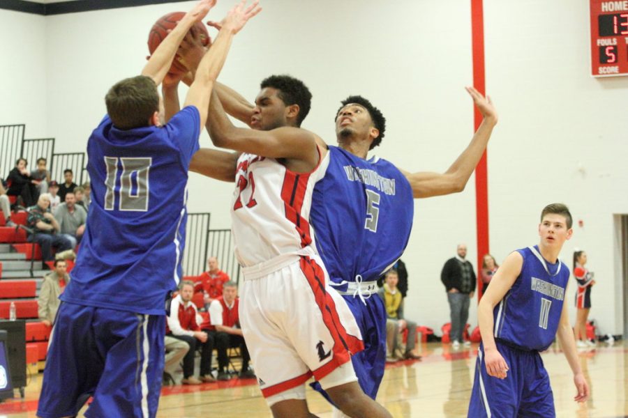 Kaleb Overall (11)  pushes through barriers to make a point for boys basketball against Washington. 