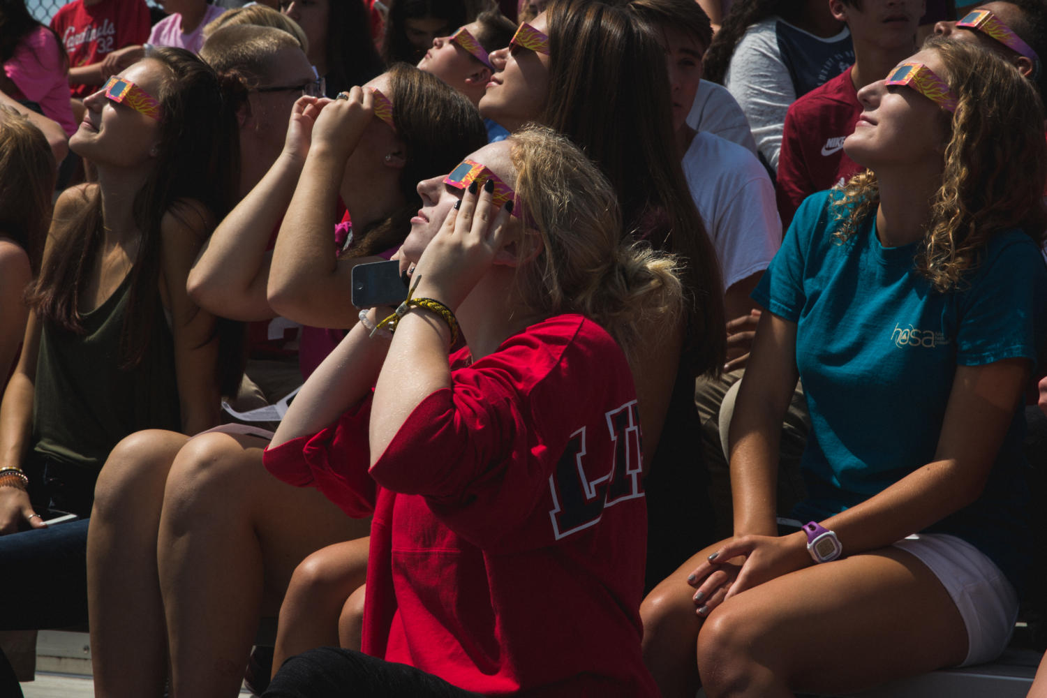 Students at Liberty witness their very first partial eclipse. The crowd talked on the football bleachers while waiting for the path of totality.