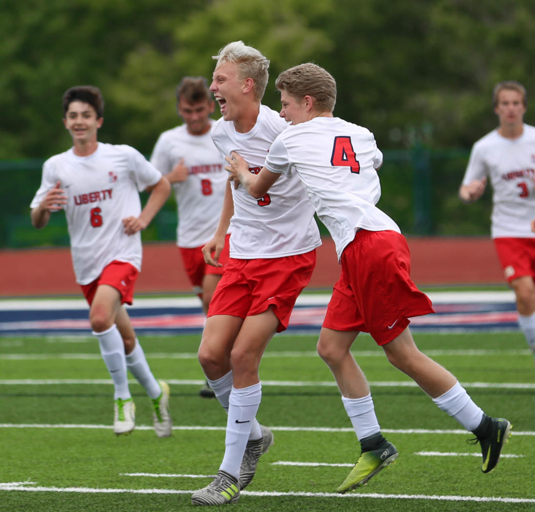 Jack Douglas and Tyler Beilsmith (#4) celebrate a goal while the rest of the team join them. The Eagles are in first place in the Gateway Athletic Conference.  