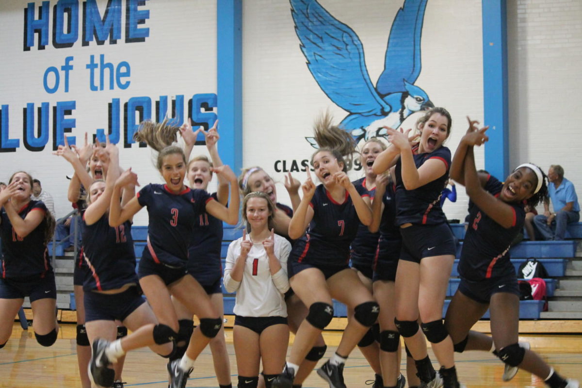 The Liberty girls freshman volleyball team celebrates their victory against Washington High School. 
