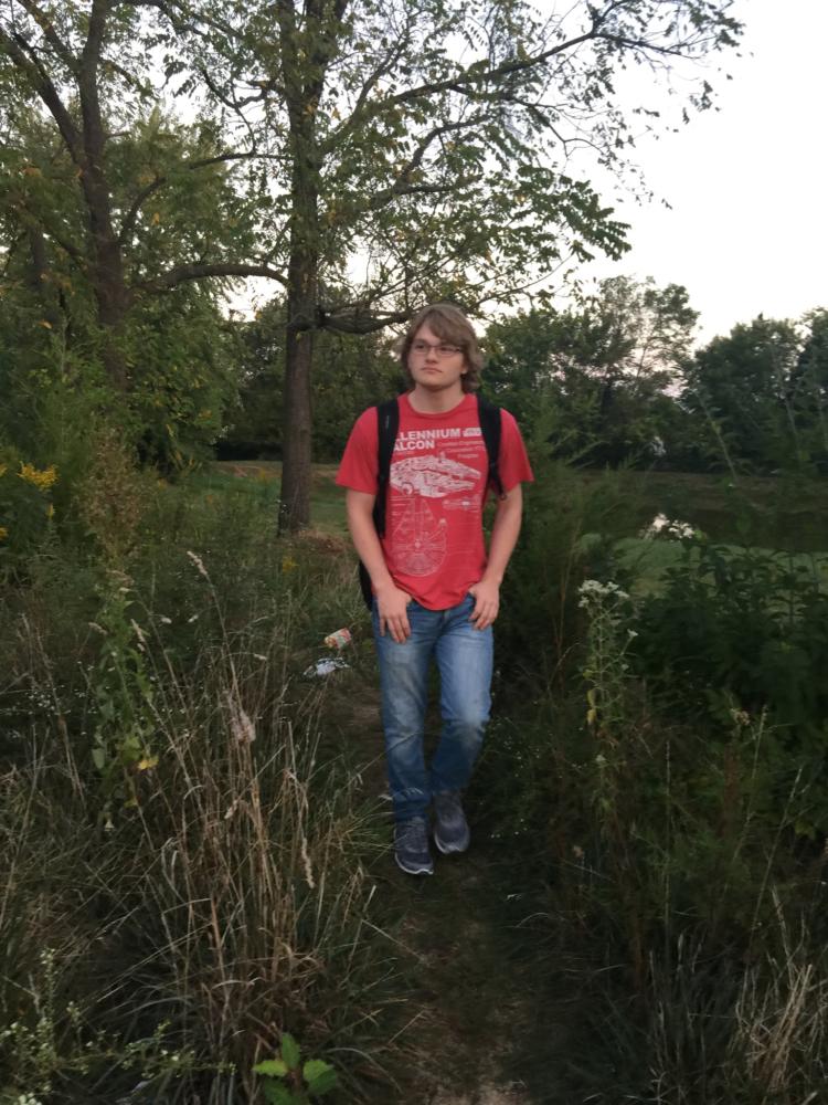 Nathan Bowsher walks to school though a trail connecting Sommers Landing and Liberty High School. 
