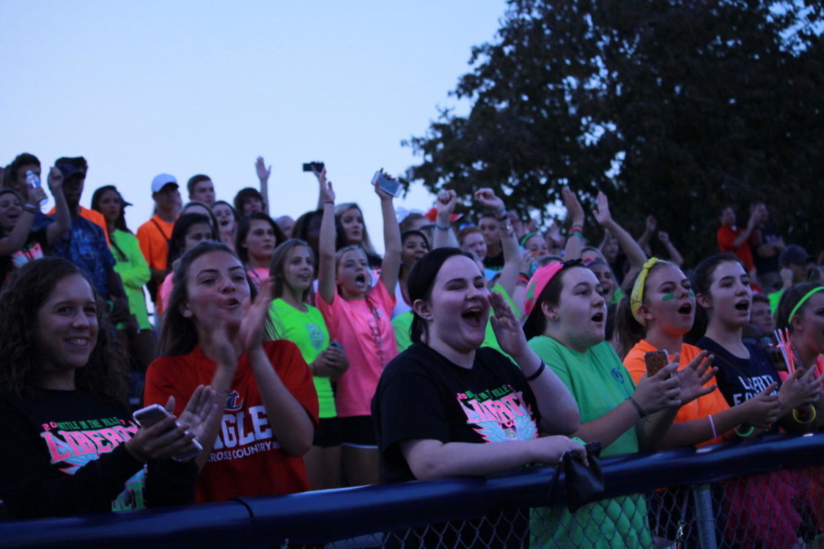 Liberty fans cheer when Eagles score during neon night at Holt. The student section has seen a lot of growth this school year.