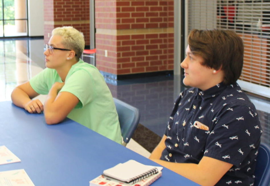 From left to right; juniors Jordyn Rector and Paxton Linnemeyer compose two out of four members on the Gay Straight Alliance (GSA) committee. They discuss details for their plans this year at the club table at SLAMM Day. 