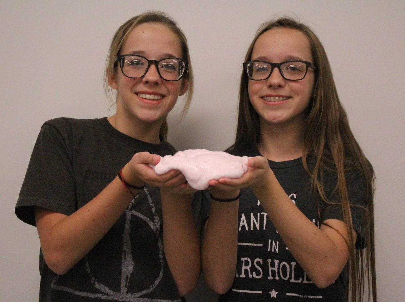 The Meinhardt twins show off one of their slime creations.