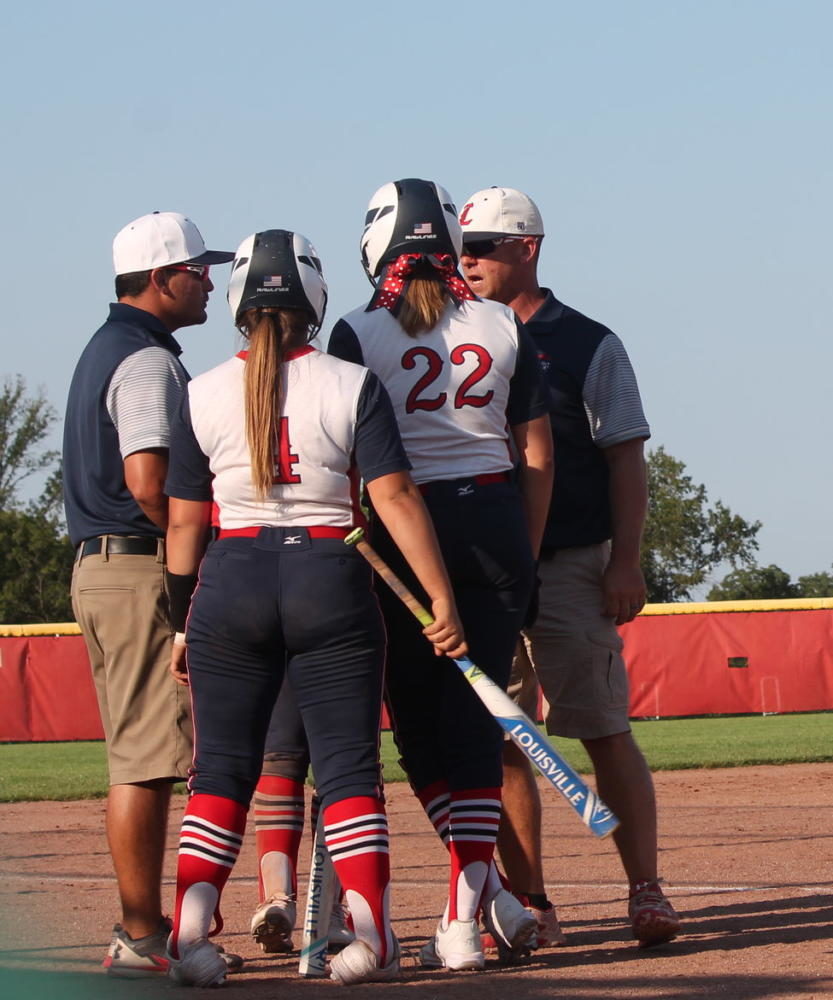 Head+varsity+softball+Coach+Flores+get+the+girls+together+to+pick+them+up+for+the+game.