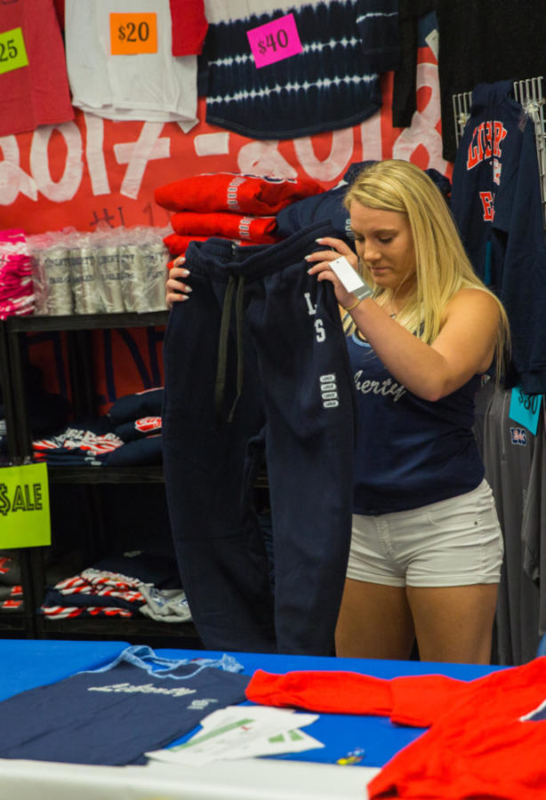 Daniele Meyers sells Liberty merchandise for Booster Club at SLAMM Day in August.