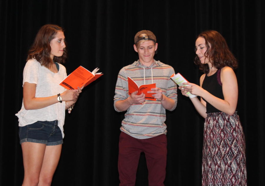 Julia Deters, Braden McMakin and Eleanor McCrary read their lines at practice. 
