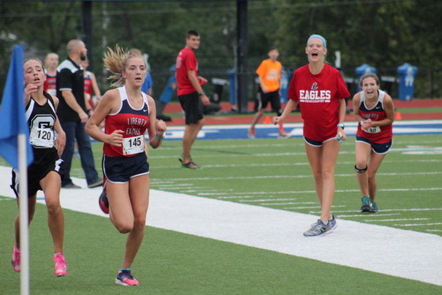 Freshman Hannah Behlmann runs to the Finish Line.