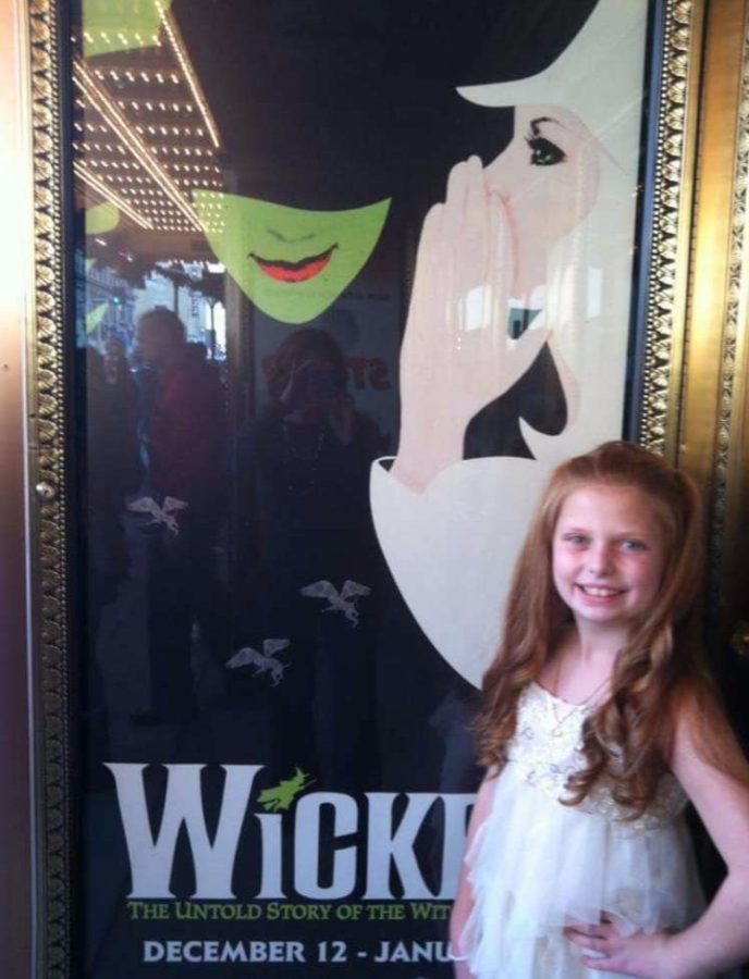 Abby Jordan stands in front of the Wicked poster at the Fox. Jordan was one of the lucky fans to get Hamilton tickets for the April performance. 