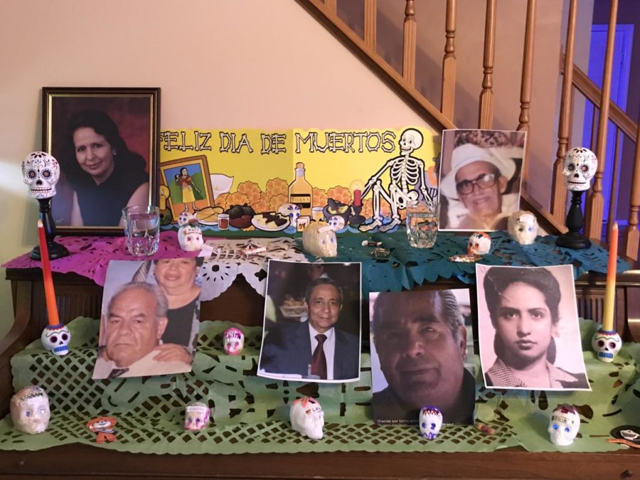 A picture of my ofrenda and like the one in Coco. Its decorated with pictures of my family members, sugar skulls and candles.