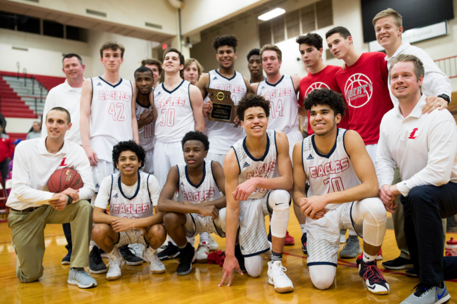 The basketball team celebrates their district championship victory against Fulton