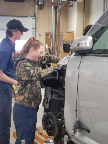 Molly Smart, senior at Liberty, shows her knowledge in Collision Repair.