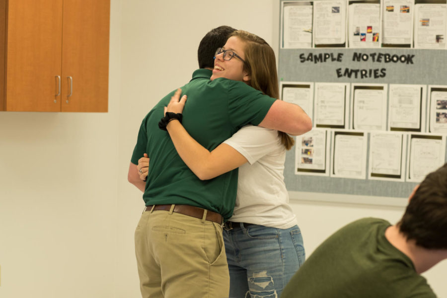 Mr. Peggs hugs Key Club president Mikayla Bowman after receiving the money that was fundraised.