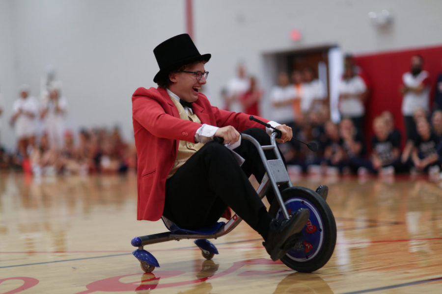 Senior Carson Brown wheels out onto the floor, kicking off the 2018 Homecoming pep rally. 