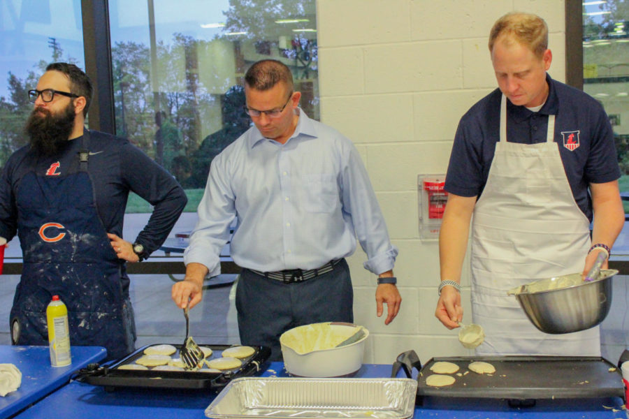 Left to right: Mr. Schumacher, Mr. Nelson, and Mr. Cole help the Class Committee make pancakes.They had skillets, pancake bars and waffle makers, which in total, made about 400-500 pancakes.  