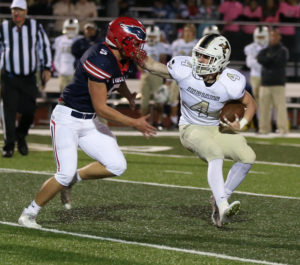 Grant Baker rushes  the Holt running back. Liberty hosts Francis Howell North on Friday. 