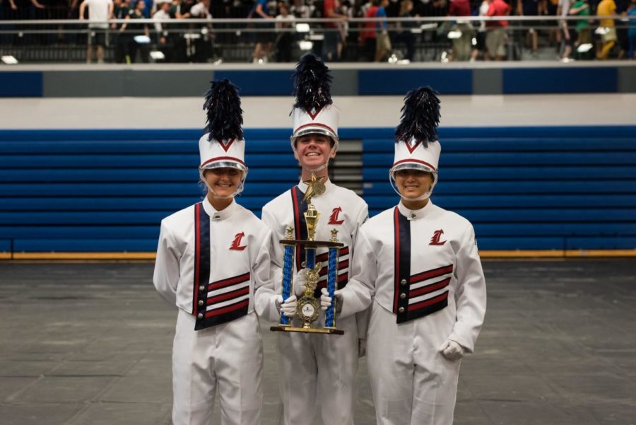Band majors Lydia Hart, Luke Carter and  Elaine Amery hold the third place trophy. 