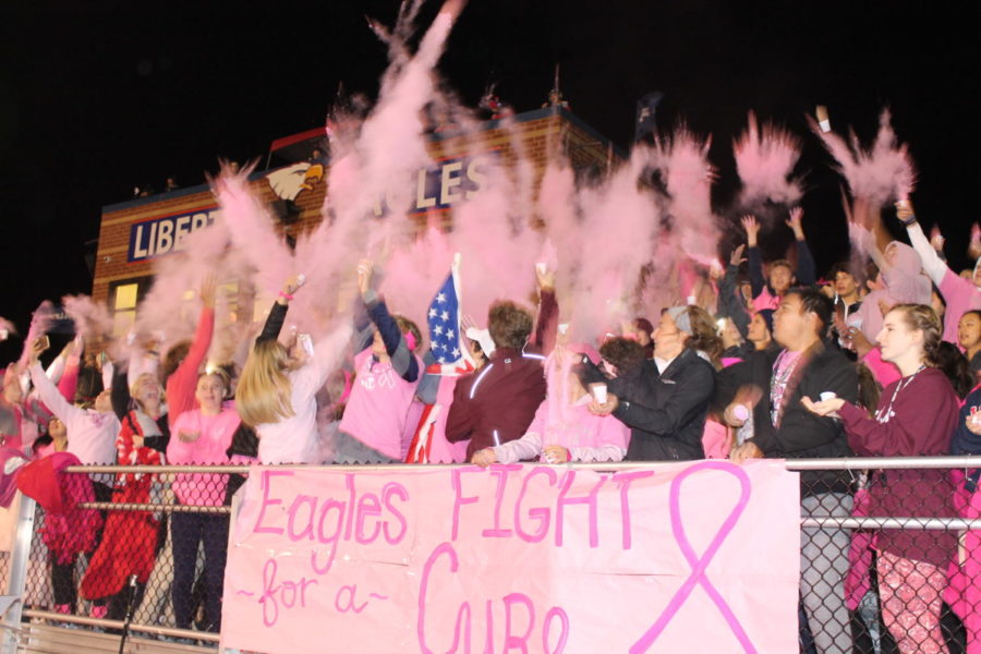 The+Liberty+student+section+tosses+up+their+pink+powder+adding+another+event+for+Pink+Night.