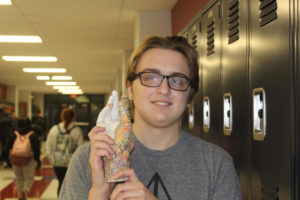 Drew Goodman features his current project - a plaster hand covered in colorful pencil shavings.