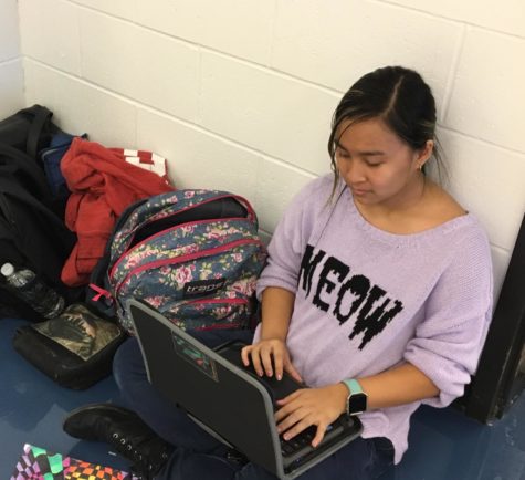 Chynna Yeh works on her writing while on a break during musical rehearsal.