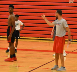 Coach Sodemann explains a drill to senior Kent Lawson and sophomore Gabe McCrary.