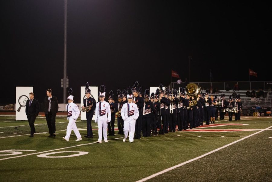 The band led by drum majors for their last show of the season.