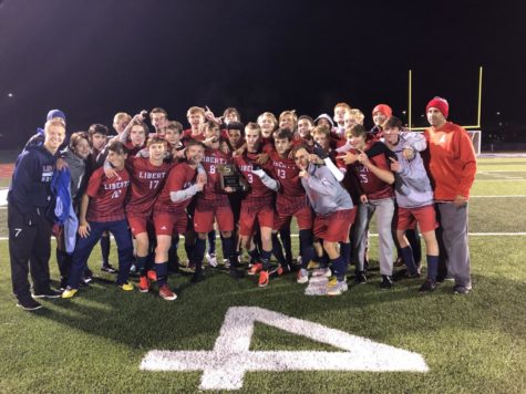 The varsity boys soccer team celebrates its district championship moments after defeating Borgia 5-0 on Thursday night.