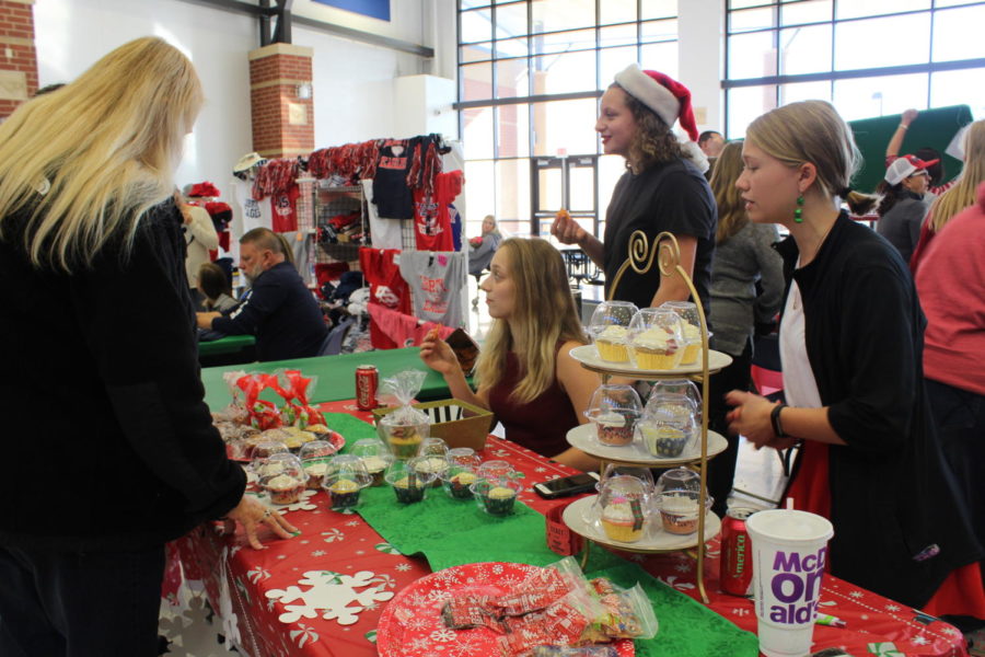Winter Guard helps at the Bazaar by selling treats for the holidays. 