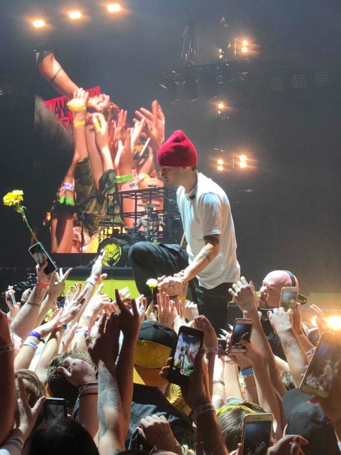 Tyler Joseph being supported by fans while singing the song Ride during the 2018 St. Louis concert. 