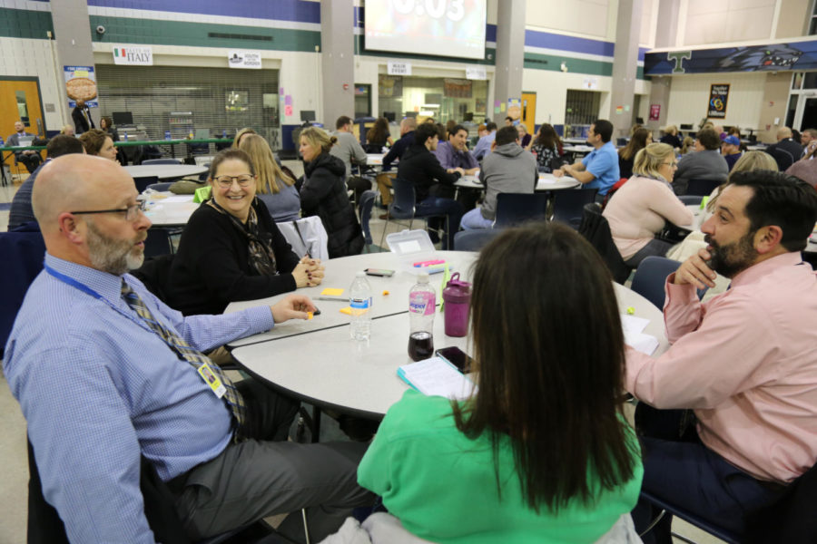 Crossroads principal Damian Fay (left) and Lakeview principal Douglas Holler (far right) discuss some items that surprised them during the meeting.