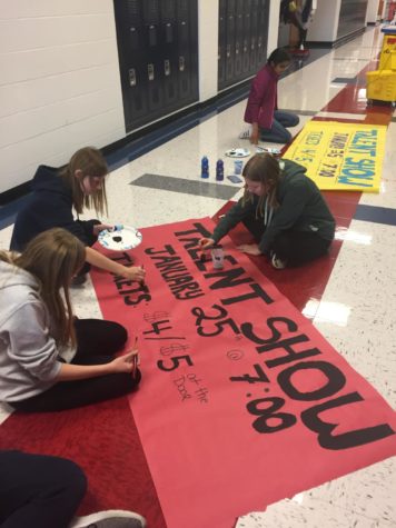 Key Club members create signs to promote the upcoming Talent Show. 