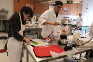 Students prepare meals for staff members on Valentines Day. 