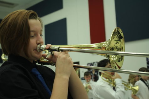 Sophomore Abby Shields warms up with her trombone before her concert.