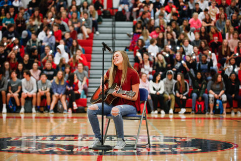 Talent show winner Dessa Outman (11) performs her original song, Dont Let Me Go, at the winter pep assembly. 