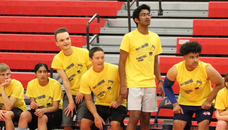 Students basketball players watch the action at the Swofford game. 