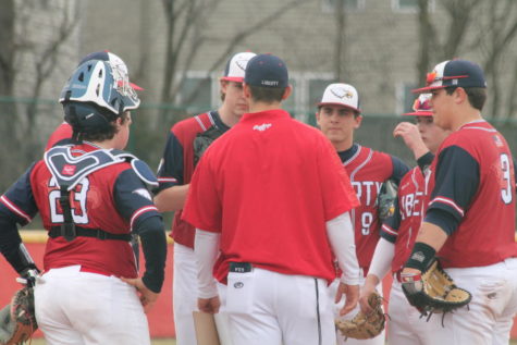 Coach Clements talks to the team at the mound in a game against Hannibal. The Eagles won 13-3 on March 19.