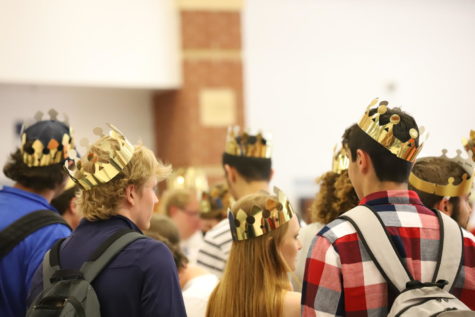Seniors don their crowns and wait to make their entrance at the assembly.