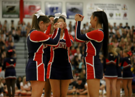 Cheerleaders prepare for their routine during their performance at the first day assembly. 