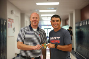 Mr. Eldredge (left) and Mr. Glavin (right) pose with the medal they won for the race back in 2020. 