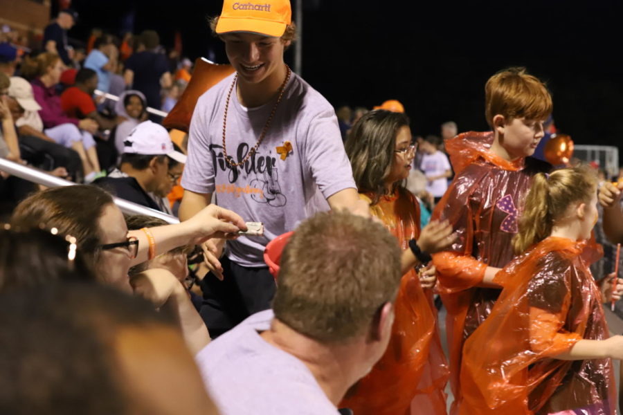 Senior Benjamin Ptasienski collects money during the miracle minute during the last minute of halftime. 
