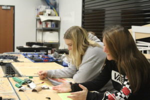 Freshmen Madeline Gamache and Samantha Knickmeyer work on a project in tech. theatre. 