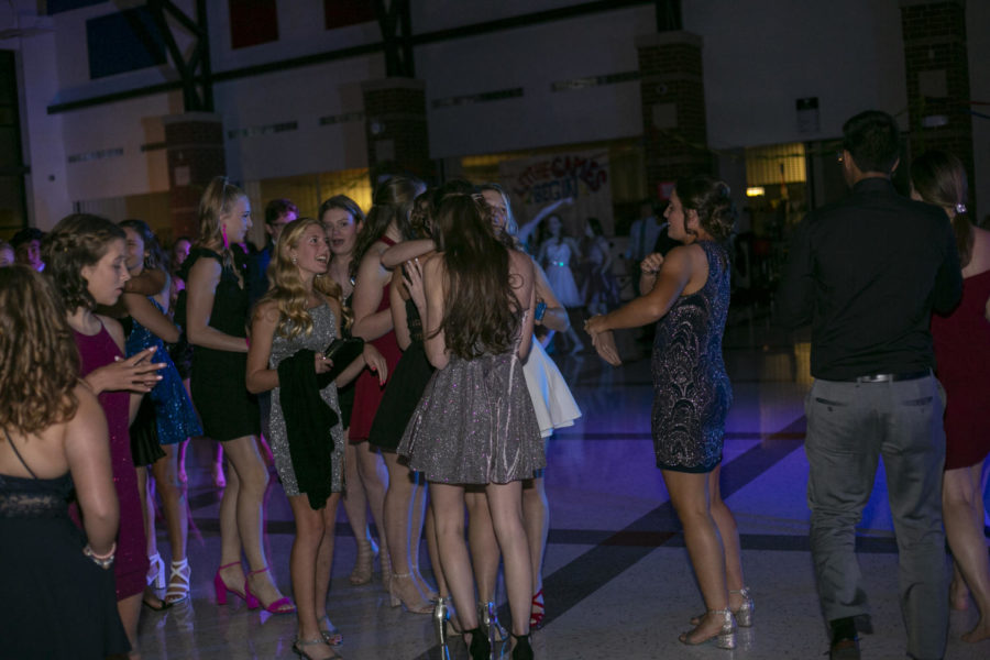 A group of girls talk together on the dancefloor