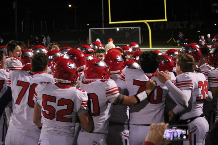 The Liberty varsity football team celebrates after their big win at Holt. 