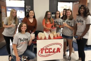 FCCLA members Audrey Champers (left) and Katelyn Yoder (middle) setting up the coffee stand