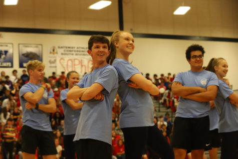Carter Kussman (12) and Hailey Forck (12) strike a pose after finishing their Belles and Bros dance. The tradition is a crowd favorite during the Homecoming pep rally. 