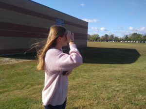 Senior Paige Eikel looks into color blind glasses to see certain colors for the first time. 