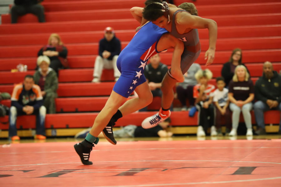 Freshman Gabriel Ostrander takes down his opponent with a double-leg in a match on Dec. 3. 